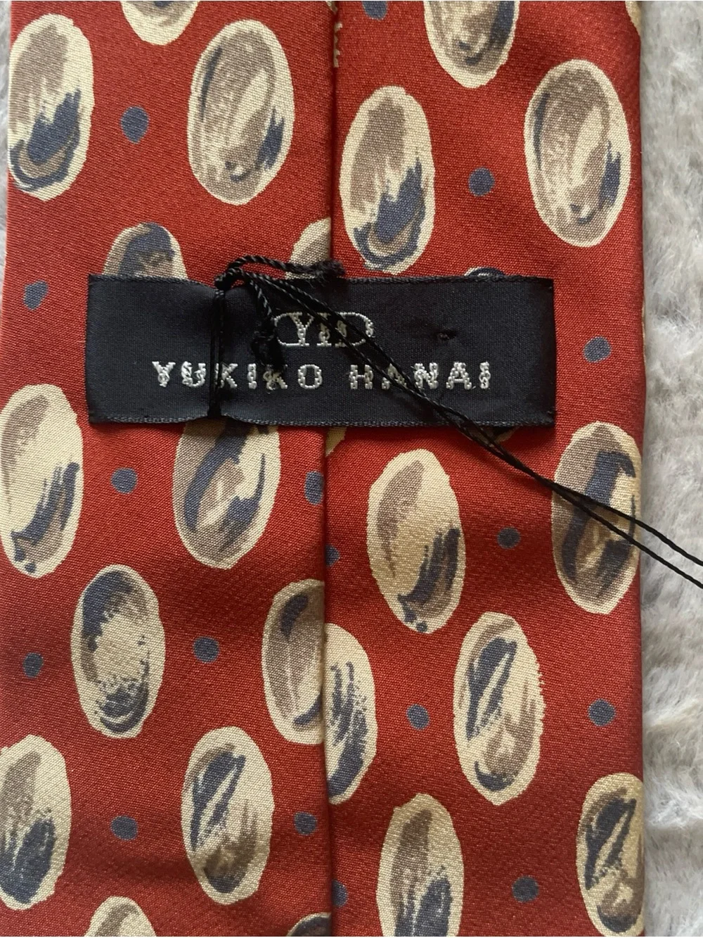 Yukiko Rust Red Silk Tie with Navy and Cream Oval Motifs